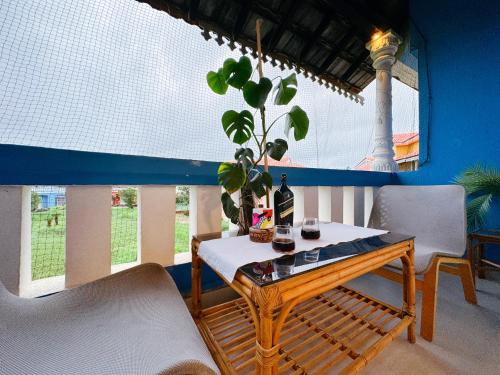 a table with a plant on it in a room at Nestwood - By The Beach Goa in Benaulim