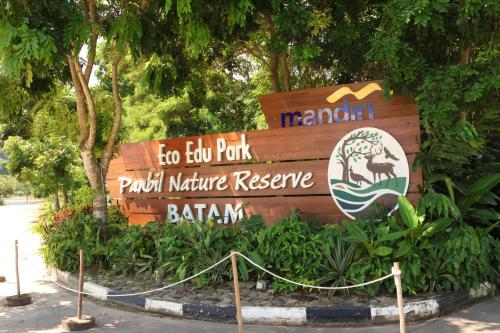 a sign for a parknature reserve in a park at Wyndham Panbil Batam in Batam Center