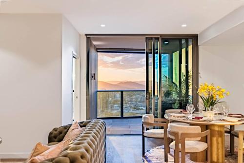 a living room with a couch and a table with a view at 3Bed Apt in Queen's Wharf - level 33 City and Riverview with Carpark in Brisbane