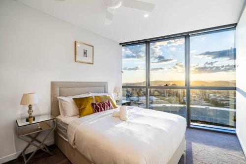 a bedroom with a large white bed and a large window at 3Bed Apt in Queen's Wharf - level 33 City and Riverview with Carpark in Brisbane