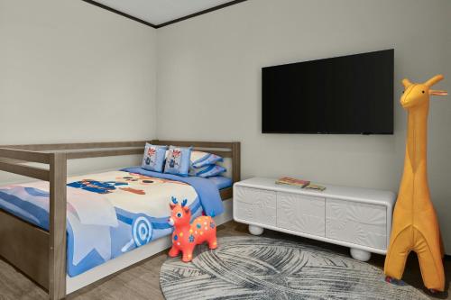 a childs bedroom with a bed and a tv at Sheraton Kunshan Dianshan Lake in Kunshan
