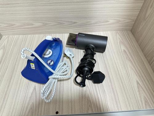 a camera sitting on top of a wooden table at NEW Batu Kawan 2 Bedrooms Suite near IKEA-Columbia Asia Hospital-BKIP-UOW Kdu in Simpang Ampat