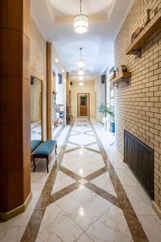 a hallway with a fireplace and a brick wall at Sacvoyage Hotel in Almaty