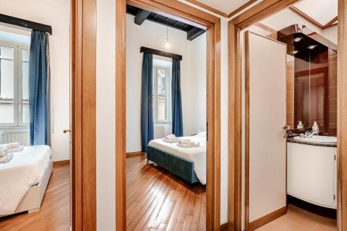 ein Badezimmer mit einem Bett und einem Waschbecken in einem Zimmer in der Unterkunft Eleganza e charme a due passi da Piazza di Spagna in Rom