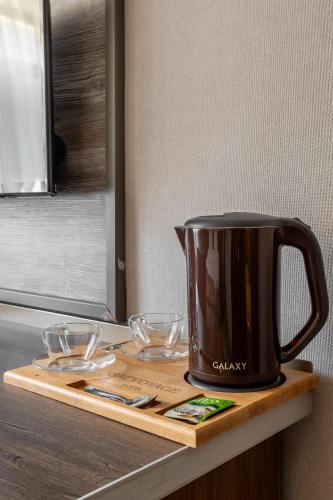 a black pot sitting on top of a cutting board at Sacvoyage Hotel in Almaty