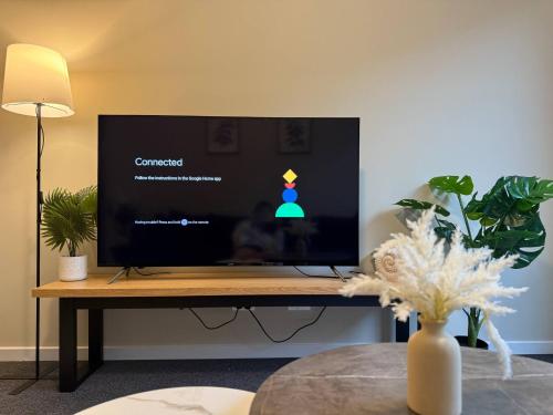 a flat screen tv sitting on top of a table at Silky Oak Stay - Brand New House in Griffin in Griffin