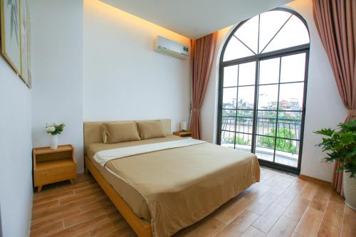 Mango Riverside Hotel & Apartment - Hai Phongにあるベッド