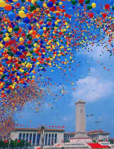 a bunch of balloons in the sky with a tower at Orange Hotel Beijing Temple of Heaven North Gate in Beijing