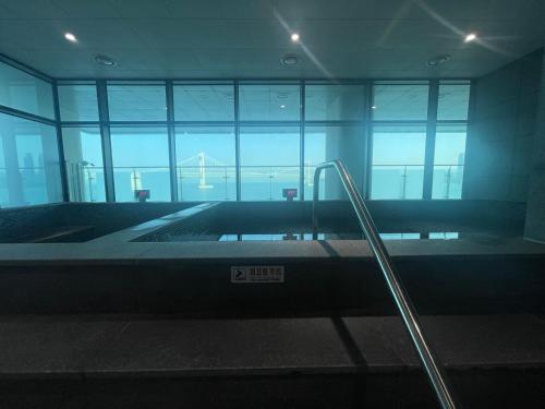 an empty room with an escalator in a building at Mool Stay in Busan