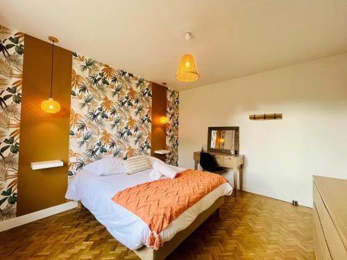 a bedroom with a bed and a desk in it at Le Logis des Pres Country Stay 