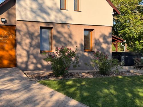 a house with a shadow on the side of it at Öregvíz Vendégház in Szentendre