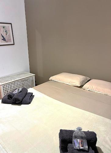two beds in a small room with towels on them at COLOR HOUSE- Lecco's Lake in Lecco