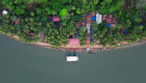 an island in the middle of a body of water at Nadhi Mane River-front Beach Stay in Tadri