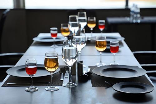a long table with glasses of wine on it at Nadhi Mane River-front Beach Stay in Tadri