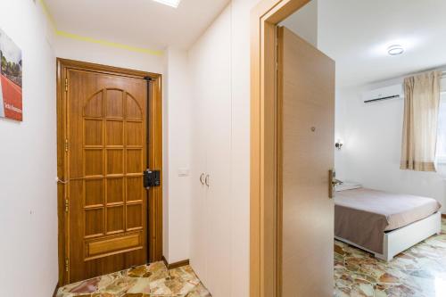a room with a door and a bedroom with a bed at Sentiti A Casa - Bronte in Bronte
