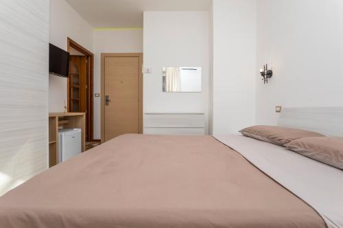 a bedroom with a large bed and a bathroom at Sentiti A Casa - Bronte in Bronte