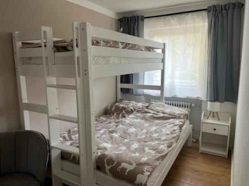 a white bunk bed in a small room at BergHerz Allgaeu in Sonthofen