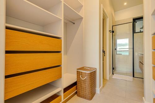 a walk in closet with wooden doors and a trash can at Le Dalblair by Horizon Holidays in Pointe d'Esny