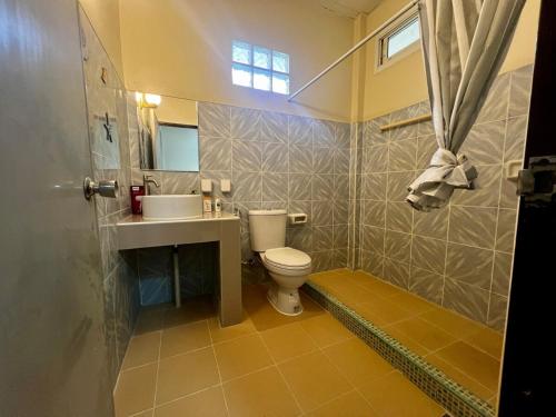 a bathroom with a toilet and a sink and a shower at One bedroom beach house near Lamai in Hua Thanon Beach