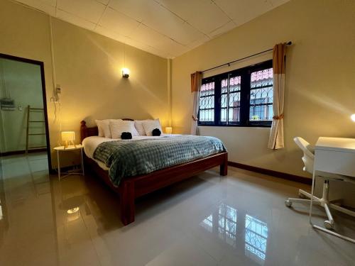 a bedroom with a bed and a large window at One bedroom beach house near Lamai in Hua Thanon Beach