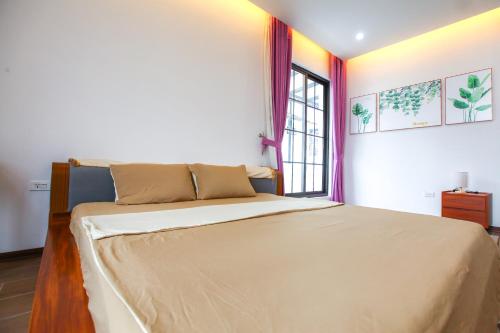Mango Riverside Hotel & Apartment - Hai Phongにあるベッド