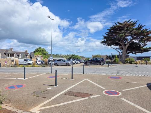 a parking lot with cars parked in a parking lot at La Flibuste, Vue Mer, Plage à Pied & Parking in Plérin