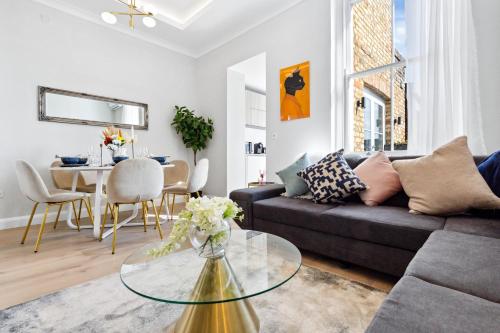 a living room with a couch and a table at The Notting Hill Villa in London