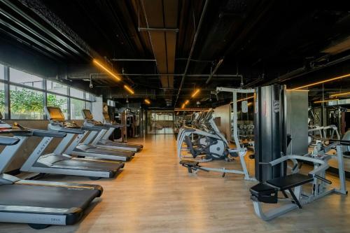 a gym with a row of treadmills and machines at Residence Inn by Marriott Rio de Janeiro Barra da Tijuca in Rio de Janeiro