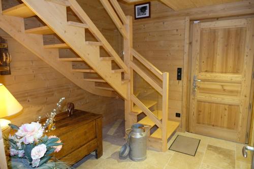 a wooden staircase in a room with a wooden wall at Chalet Le Petit Suisse in Thollon