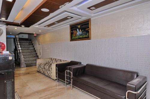 a waiting room with a couch and stairs at Hotel O The Moon in New Delhi