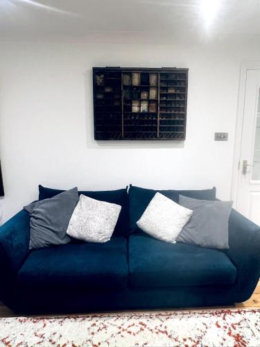 a blue couch in a living room with pillows on it at Large one bedroom beach apartment in Bel Royal