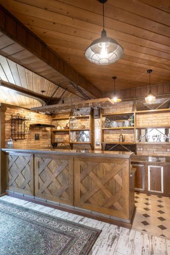 a large room with a barn with wooden walls and a bar at Sacvoyage Hotel in Almaty