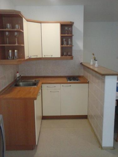 a kitchen with white cabinets and a sink at Motel and Restaurant Odušak in Drežnjak