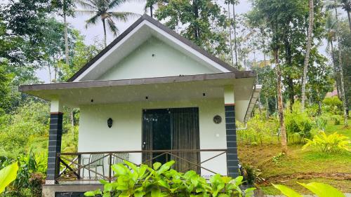 a small house in the middle of a forest at The village vista in Batheri