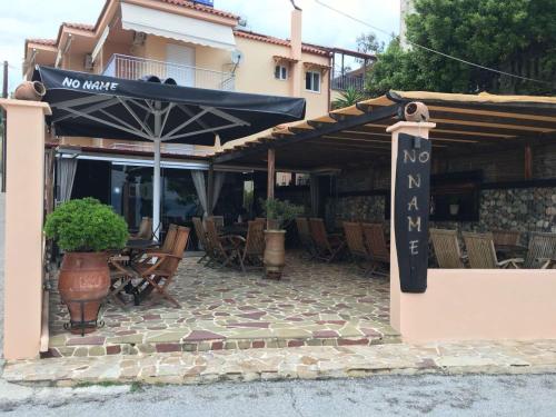 a restaurant with a no market sign on a patio at Despoina Apartments in Edipsos