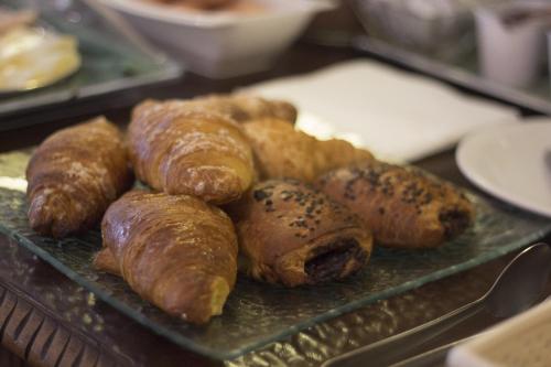 a tray of pastries and croissants on a table at Hotel Portici in Vicoforte