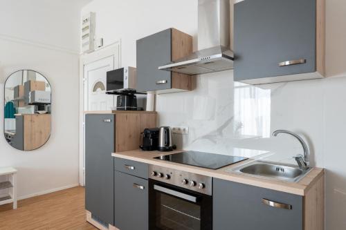 a kitchen with a sink and a refrigerator at FarawayHomes Studios Klosterneuburg in Klosterneuburg