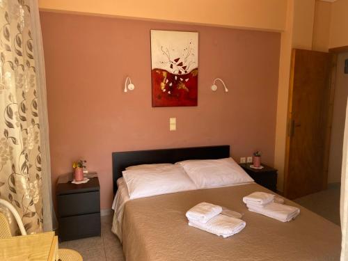 a bedroom with a bed with two towels on it at Despoina Apartments in Edipsos