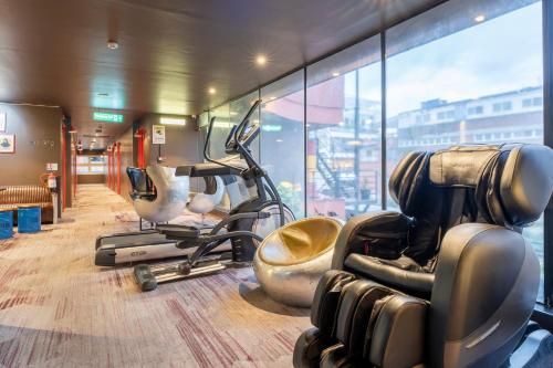 a gym with cardio equipment and a large window at Gaas BaasCo in Kathmandu