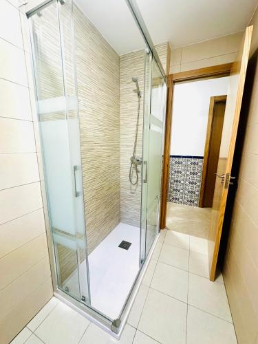 a shower with a glass door in a bathroom at VUT La Ermita in Arenas de San Pedro