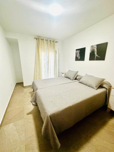 a bedroom with a large bed and a window at VUT La Ermita in Arenas de San Pedro