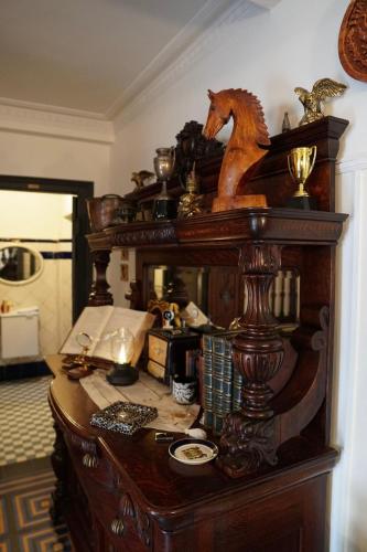 a wooden desk with a horse statue on top of it at Casa Puebla Historia y Elegancia in Cangas de Onís