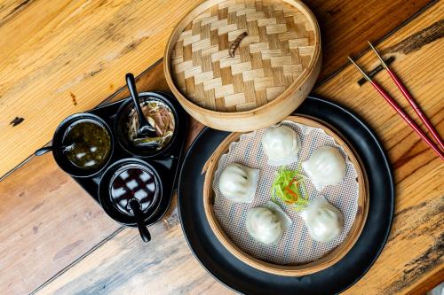 a table with two bowls of food and a bowl of oysters at Gaas BaasCo in Kathmandu