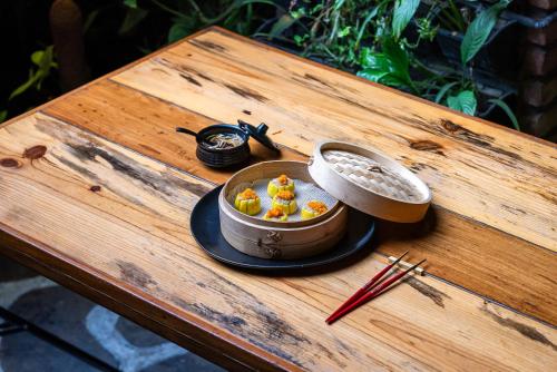 a bowl of food sitting on a wooden table at Gaas BaasCo in Kathmandu