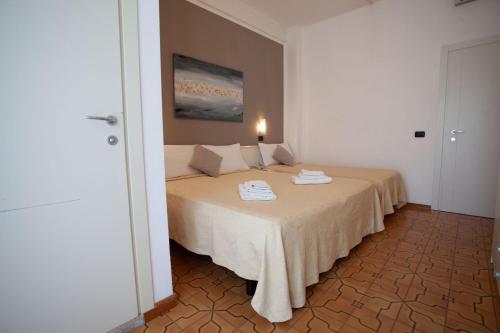 a bedroom with a bed with two towels on it at HOTEL CONTI in San Mauro a Mare