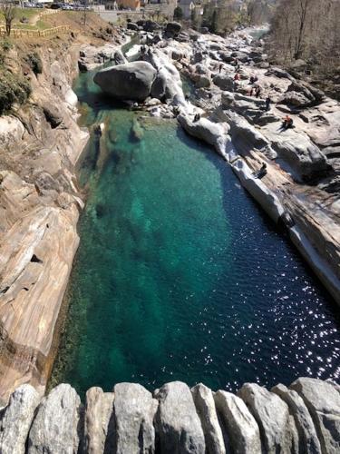 an aerial view of a body of water with rocks at Casa Aviva in Muralto
