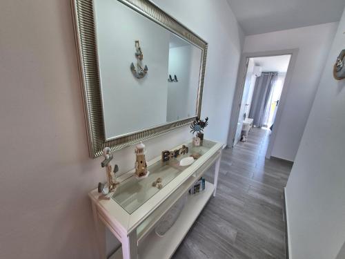 a bathroom with a sink and a large mirror at Rincon de Maruca Atico C in Gran Tarajal