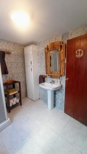 a bathroom with a sink and a mirror and a counter at Casa de los Abuelos in Cardeña