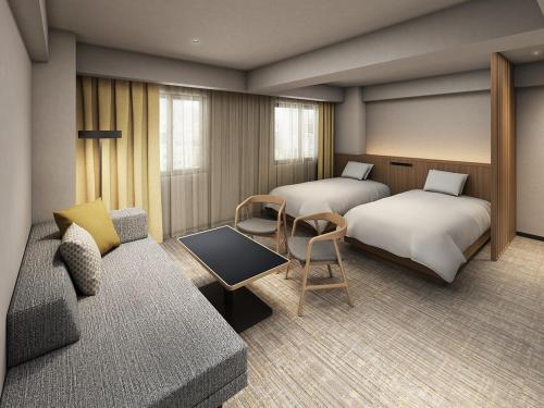 a hotel room with two beds and a couch at Richmond Hotel Nagoya Nayabashi in Nagoya