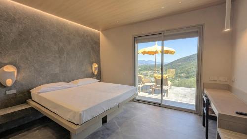 a bedroom with a bed and a balcony with an umbrella at Hotiday Lerici Trebiano in Lerici